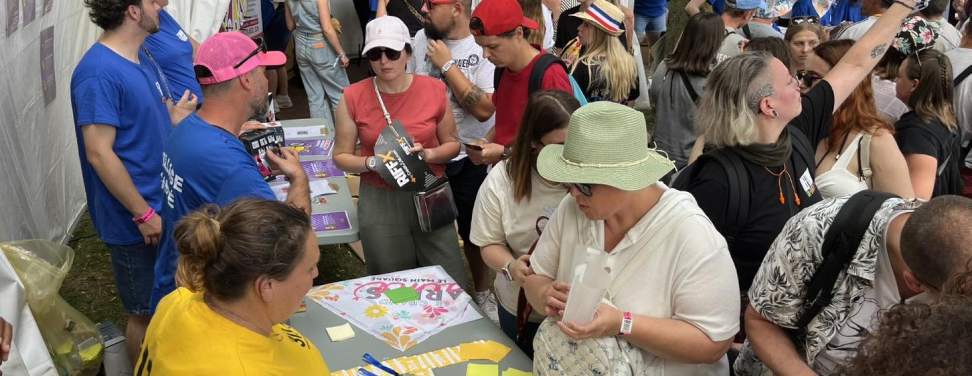 personnes devant un stand et à proximité d'un chapiteau